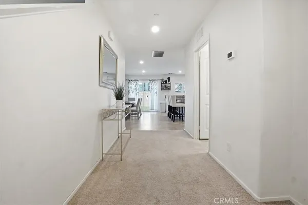 a kitchen with a sink white cabinets and chairs