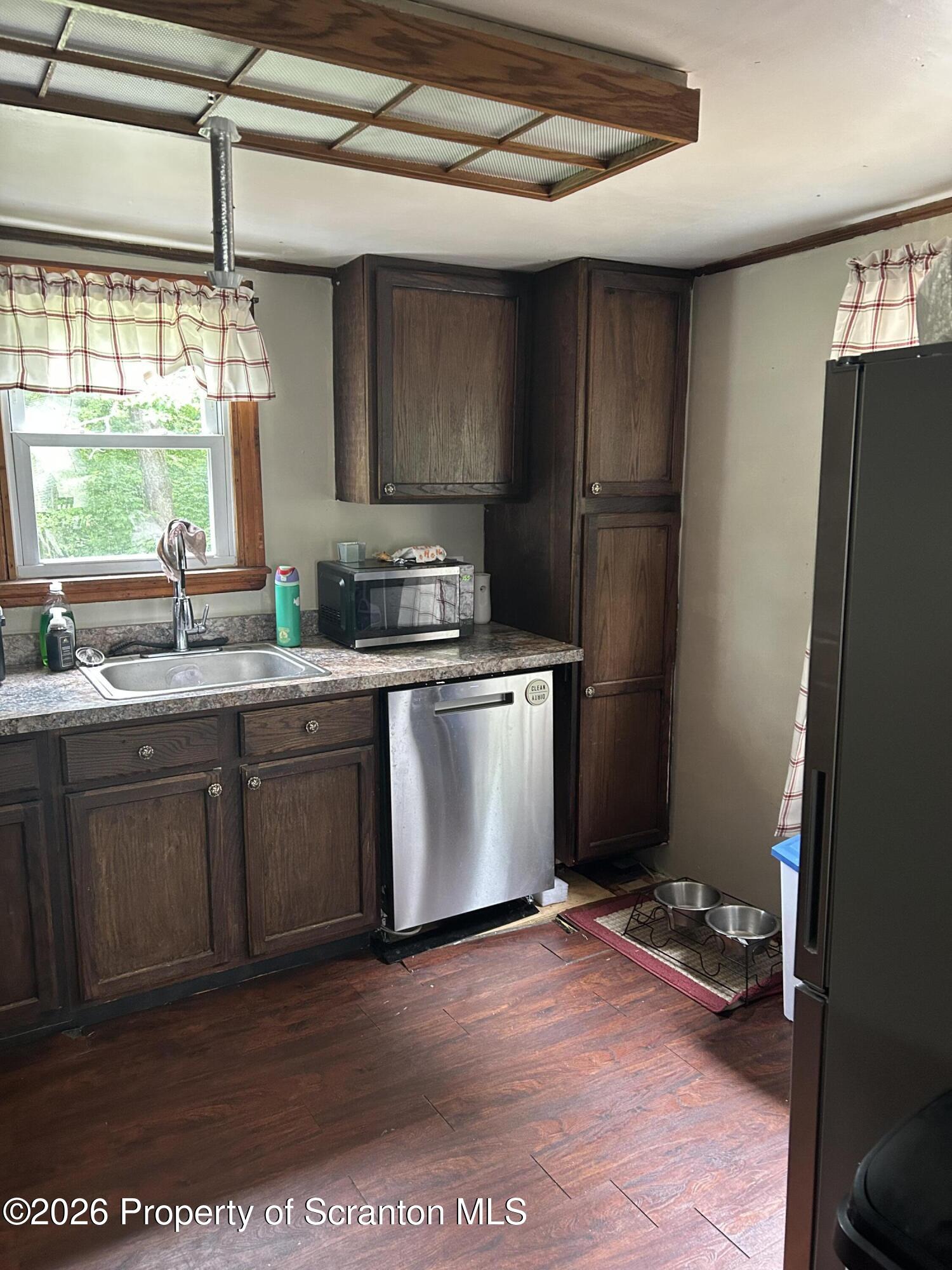 63 Shannon Street Simpson, PA 18407 - Photo 9 of 24 a kitchen with a sink stove and refrigerator