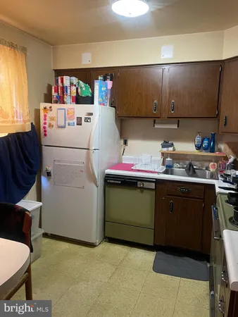 a utility room with cabinets washer and dryer