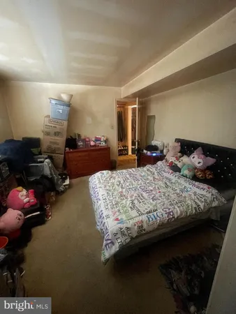 a bedroom with bed and window