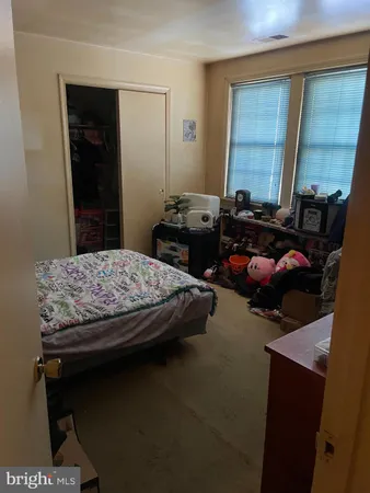 a bedroom with bed and window