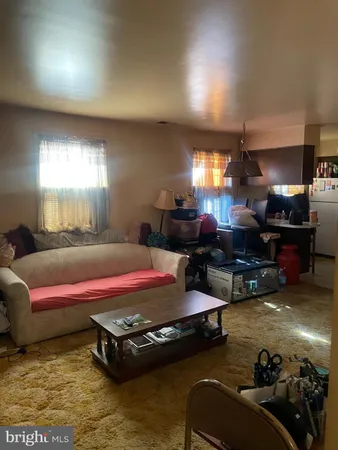 a living room with furniture pool table and a window