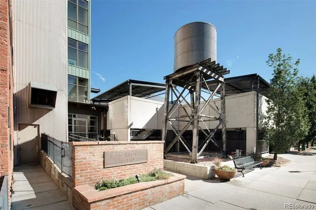 a view of a lobby with two chairs and potted plants