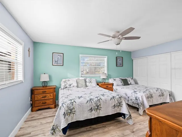 a view of an empty room with furniture and a window