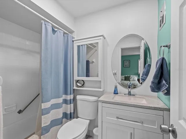 a front view of a house with a yard and table and chairs under an umbrella