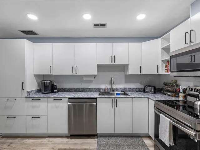 a bathroom with a toilet a sink and a mirror