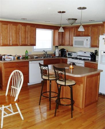 35 Lynbrook Road Methuen, MA 01844 - Photo 3 of 8 a kitchen with stainless steel appliances granite countertop a stove top oven a sink a dining table and chairs with wooden floor