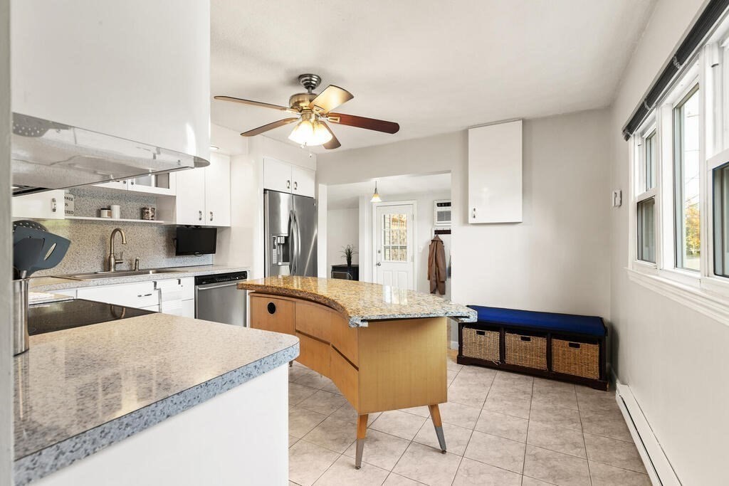 23 Appleton Street Saugus, MA 01906 - Photo 12 of 30 a living room with furniture a flat screen tv and kitchen view