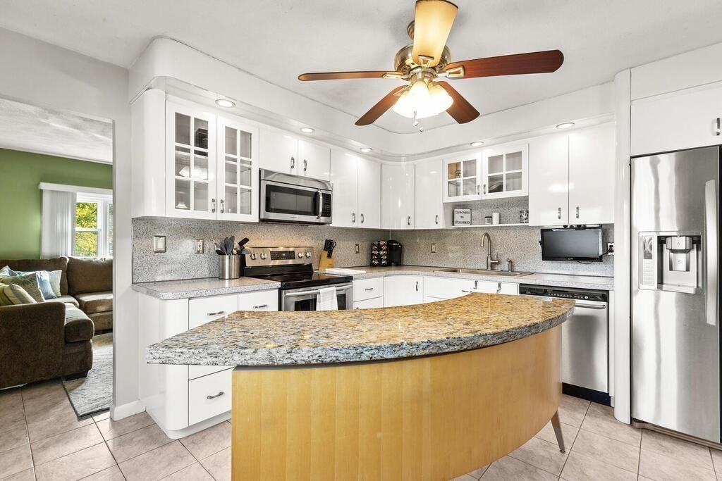 23 Appleton Street Saugus, MA 01906 - Photo 13 of 30 a kitchen with stainless steel appliances granite countertop a stove refrigerator sink and microwave