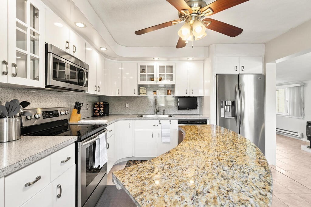 23 Appleton Street Saugus, MA 01906 - Photo 16 of 30 a kitchen with a stove a sink and a refrigerator