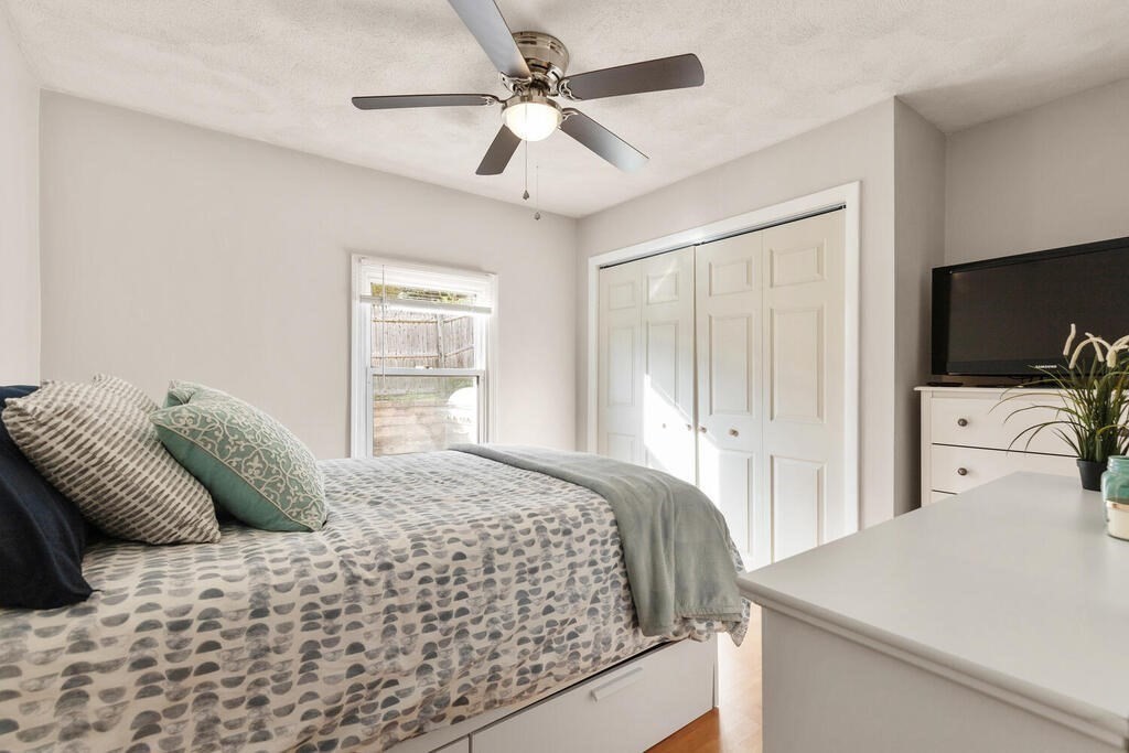 23 Appleton Street Saugus, MA 01906 - Photo 17 of 30 a bedroom with a bed and a chandelier