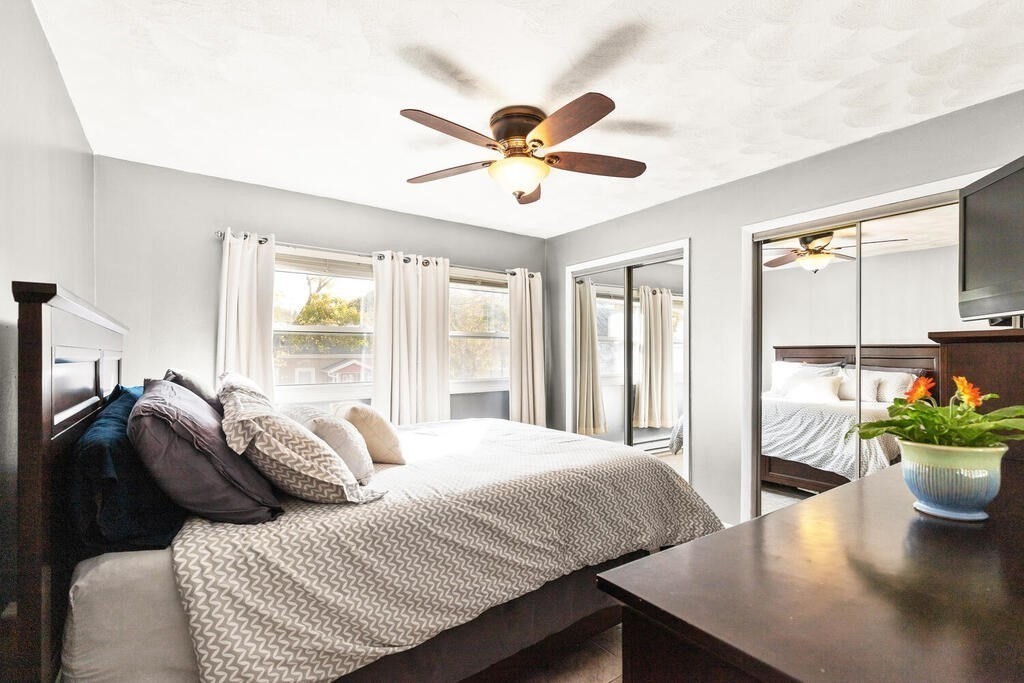 23 Appleton Street Saugus, MA 01906 - Photo 19 of 30 a bedroom with a bed and a chandelier