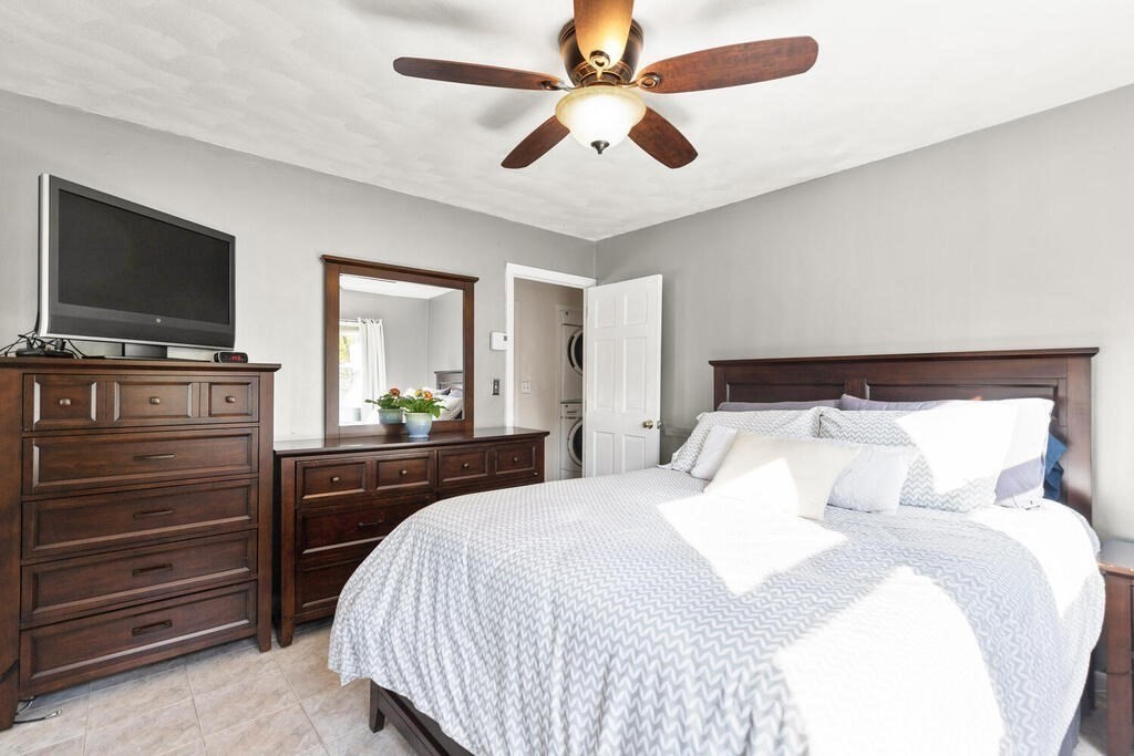 23 Appleton Street Saugus, MA 01906 - Photo 20 of 30 a bedroom with a bed and a flat screen tv