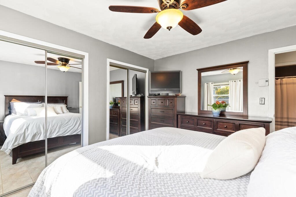 23 Appleton Street Saugus, MA 01906 - Photo 21 of 30 a bedroom with a bed and a large mirror