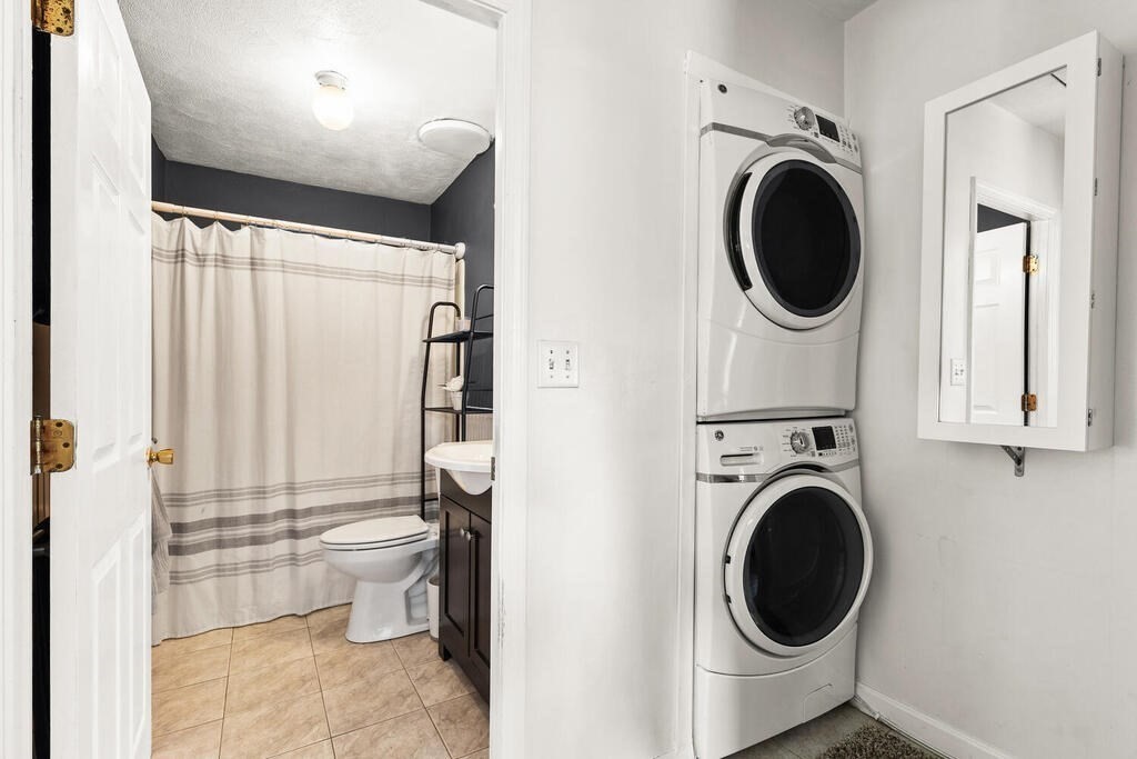 23 Appleton Street Saugus, MA 01906 - Photo 22 of 30 a view of a hallway with washer and dryer