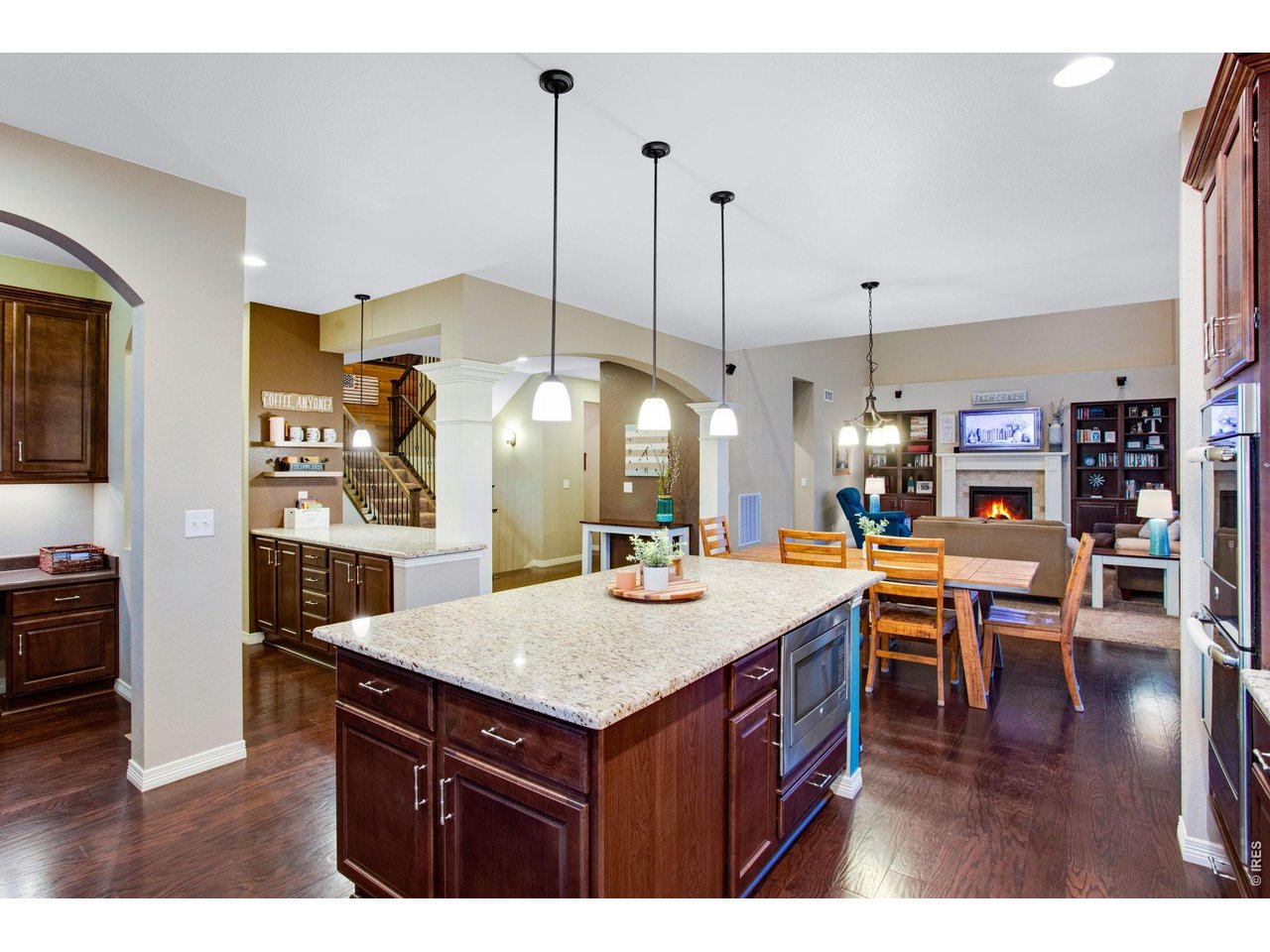 5728 Connor Street Timnath, CO 80547 - Photo 12 of 50 a kitchen with a counter and chairs