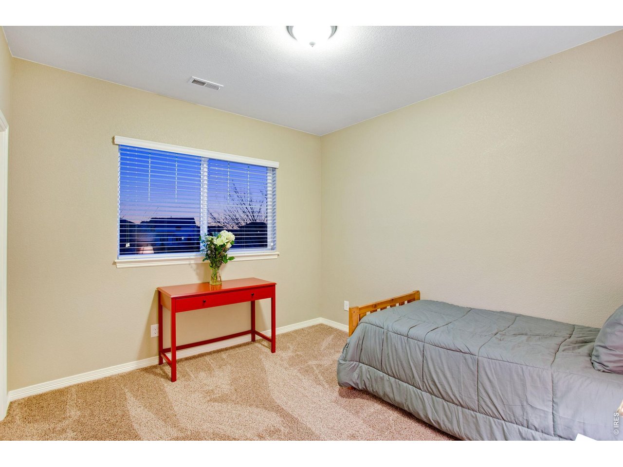 5728 Connor Street Timnath, CO 80547 - Photo 33 of 50 a bedroom with a bed and a table