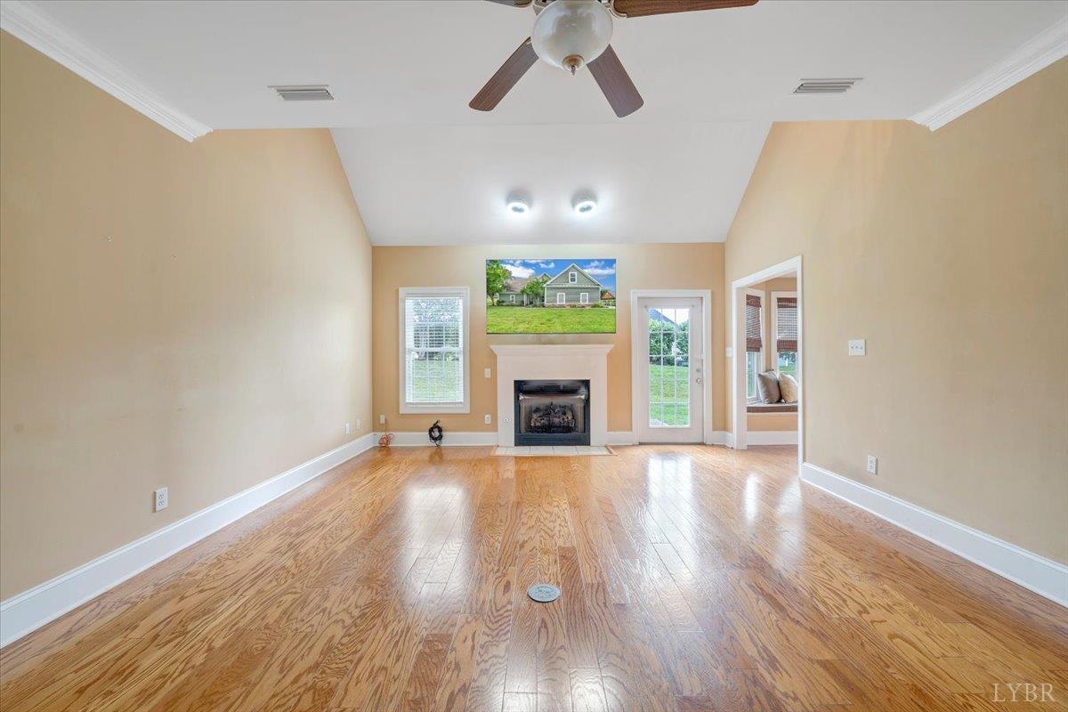 1250 Our Cove Road Huddleston, VA 24104 - Photo 8 of 70 a view of an empty room with a fireplace and a window