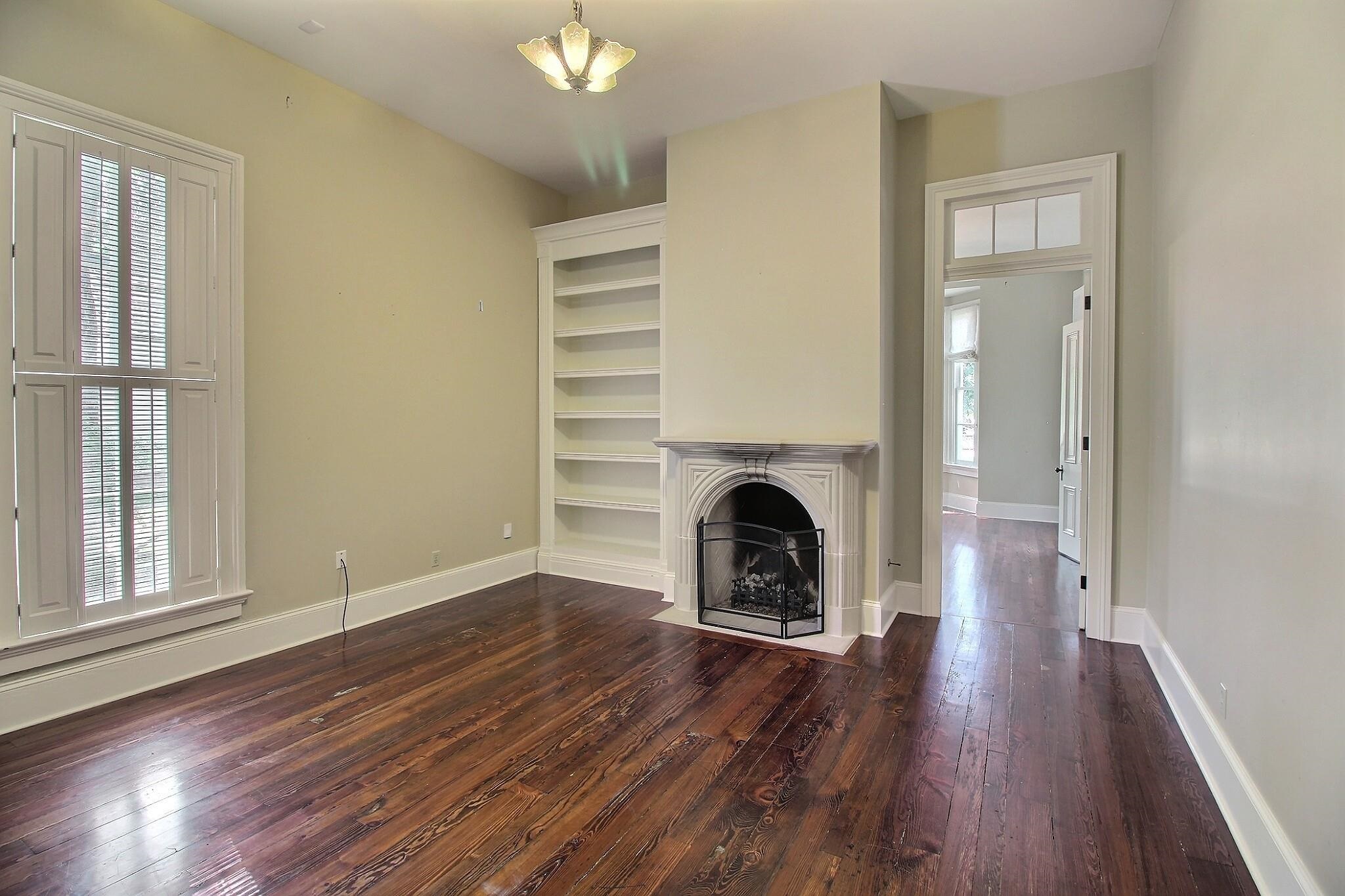 348 North Rowlett Street Collierville, TN 38017 - Photo 11 of 39 an empty room with wooden floor a fireplace and windows