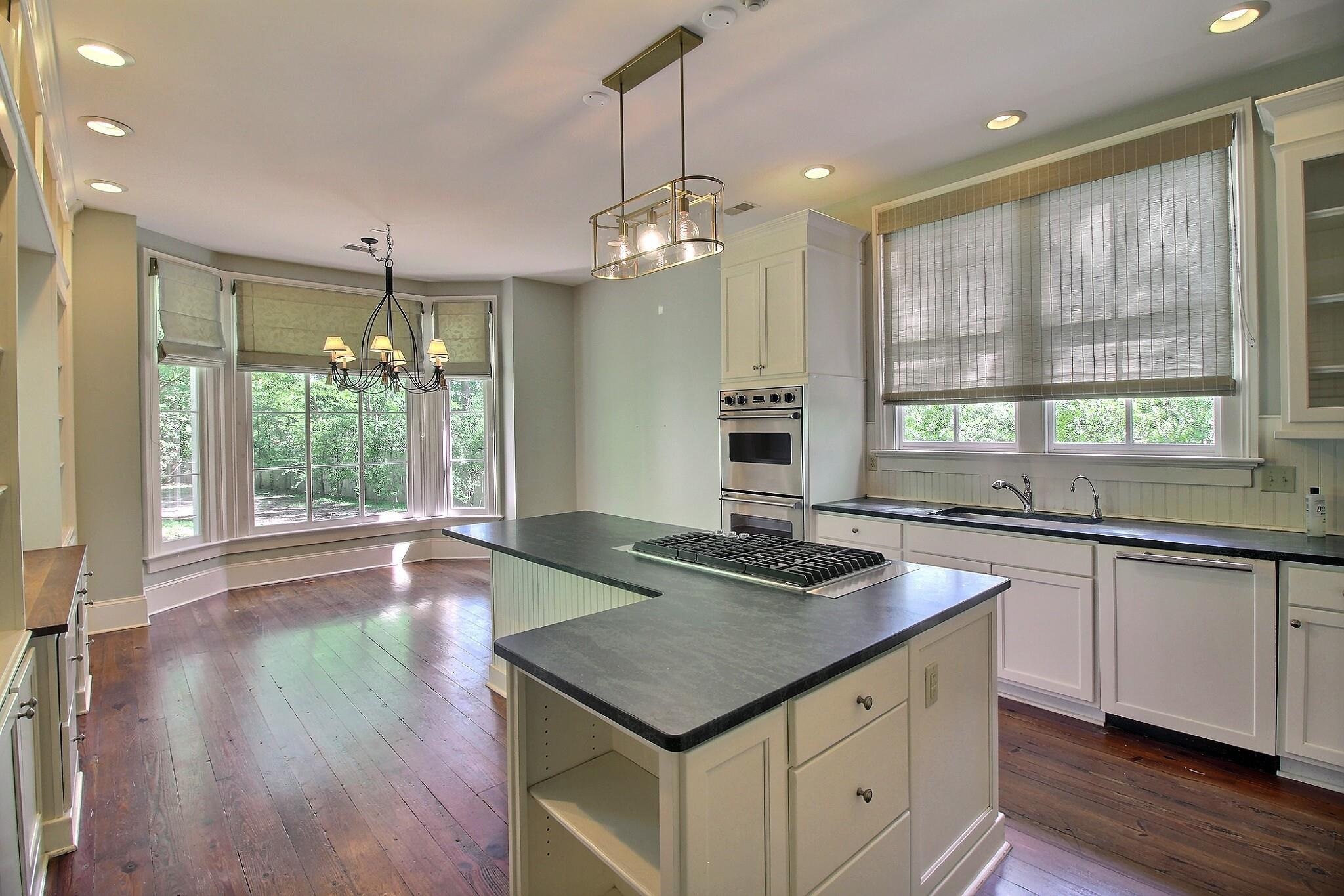 348 North Rowlett Street Collierville, TN 38017 - Photo 13 of 39 a kitchen with a counter space wooden floor and a window