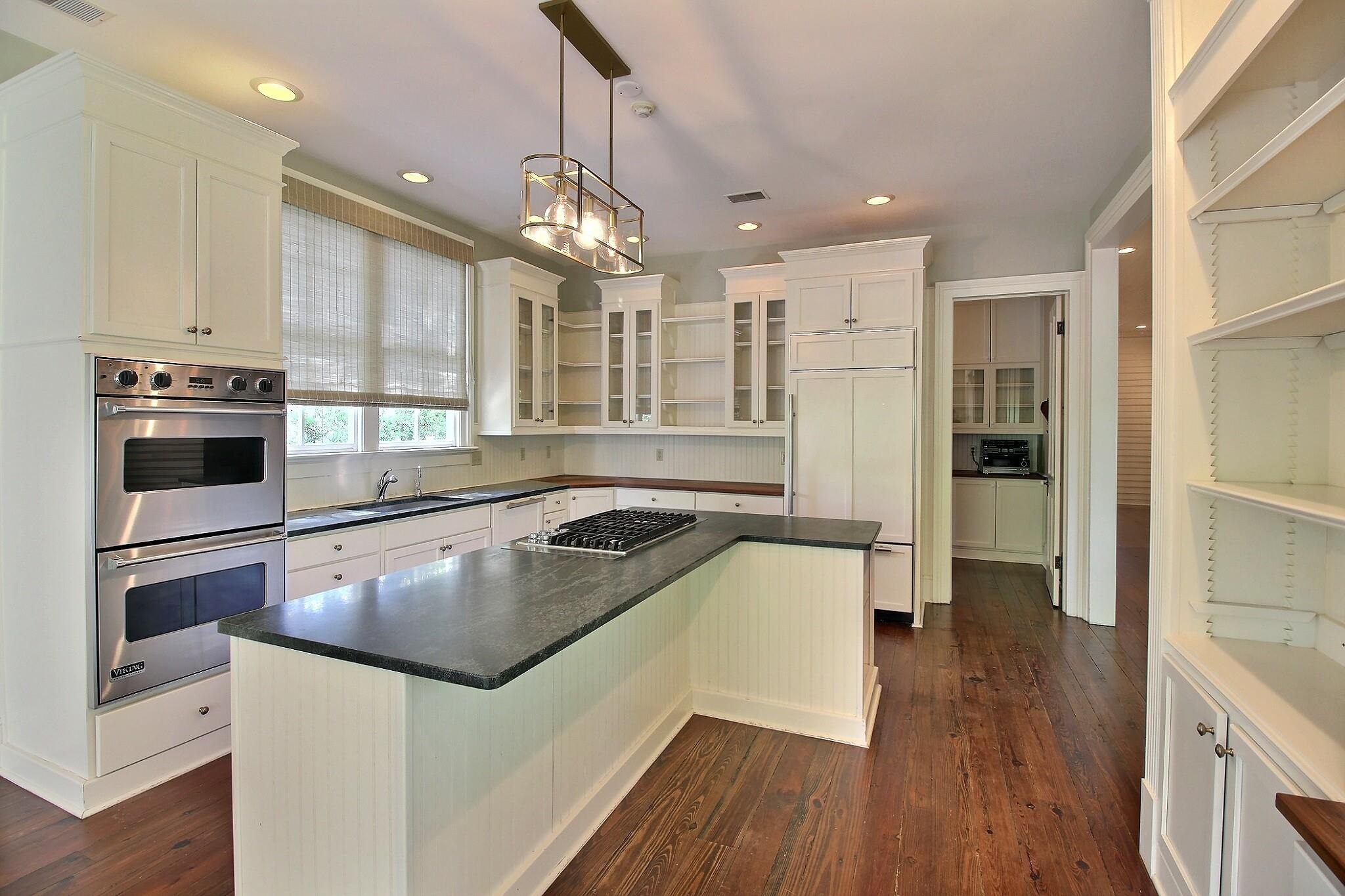 348 North Rowlett Street Collierville, TN 38017 - Photo 16 of 39 a kitchen with a refrigerator a sink and wooden floor