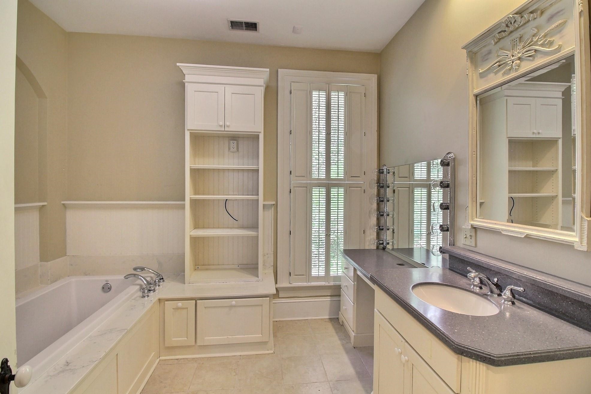 348 North Rowlett Street Collierville, TN 38017 - Photo 24 of 39 a bathroom with a tub sink and mirror