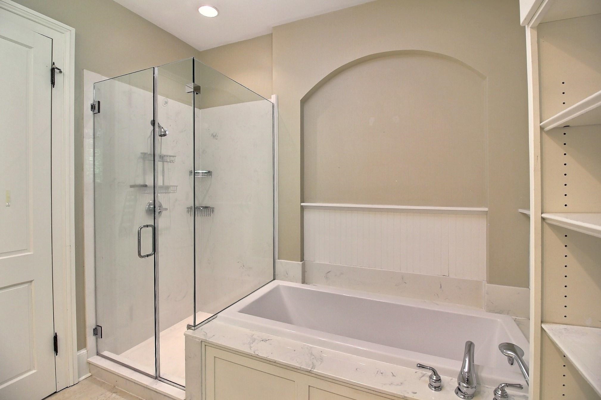 348 North Rowlett Street Collierville, TN 38017 - Photo 25 of 39 a bathroom with a tub and a shower