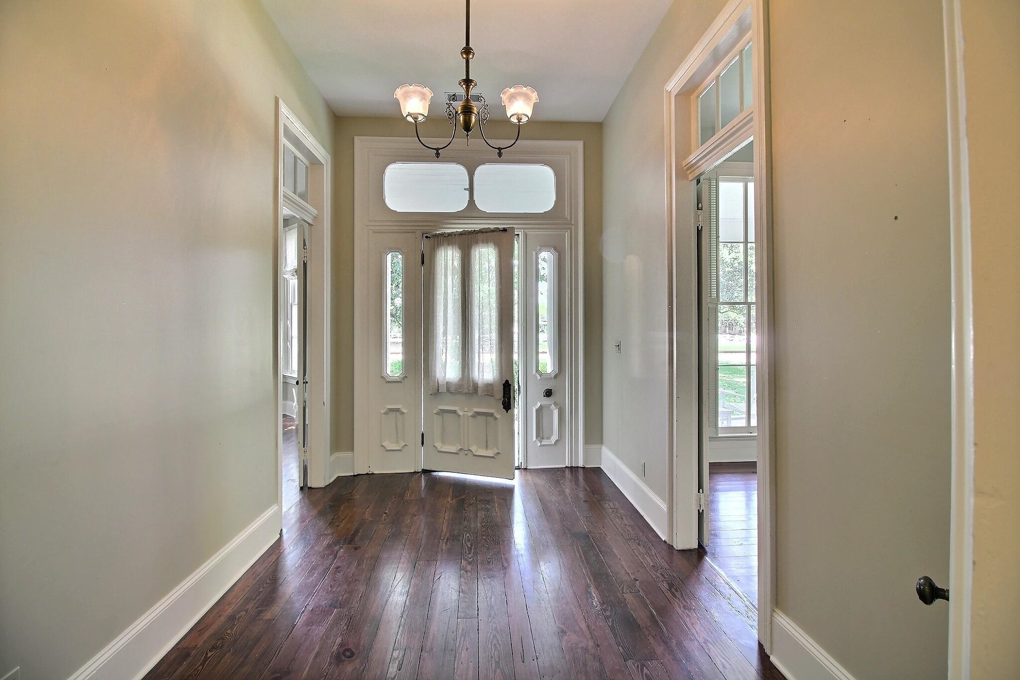 348 North Rowlett Street Collierville, TN 38017 - Photo 6 of 39 a view of a hallway with wooden floor and chandelier