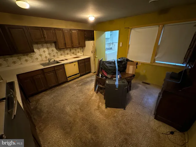 a kitchen with a sink appliances and cabinets