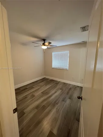 a view of a room with wooden floor and cabinet