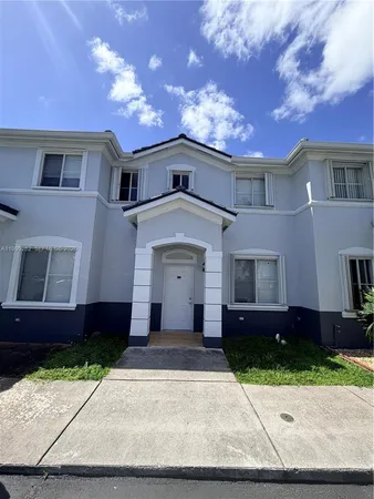 a front view of a house with yard