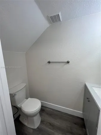 a white toilet sitting next to a sink