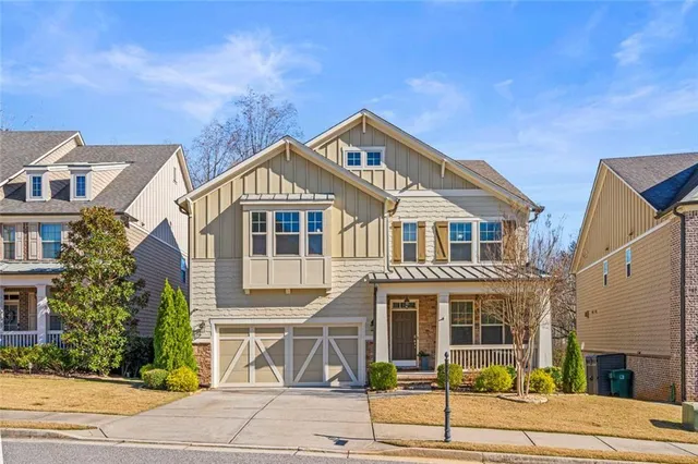 a front view of a house with a garden