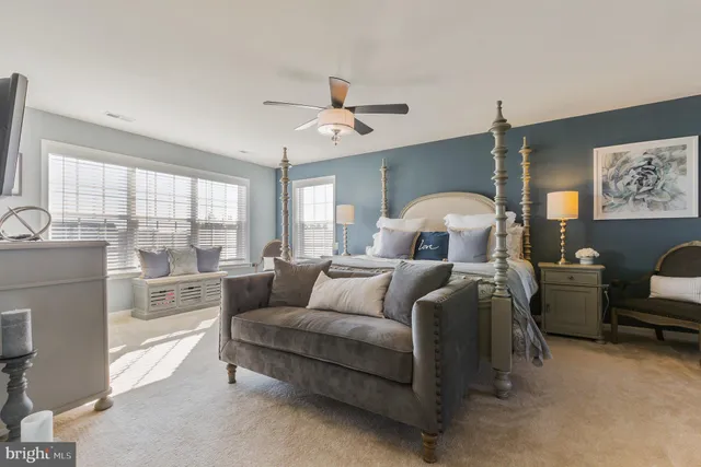 a bedroom with bed and a large window