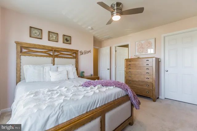 a front view of a house with a yard and green space