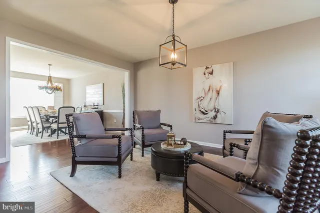 a living room with furniture or couch and a chandelier