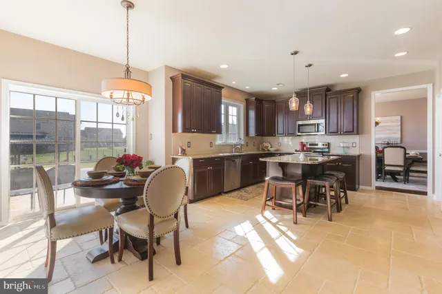a kitchen with stainless steel appliances kitchen island granite countertop a sink and cabinets