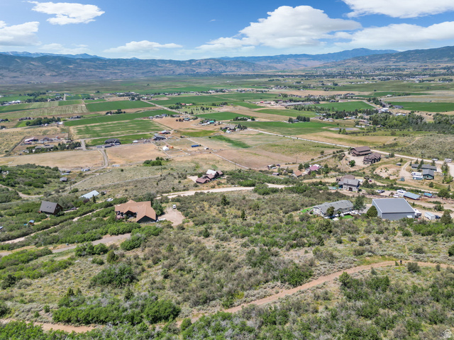 2459 Painter Road Marion, UT 84036 - Photo 34 of 42 Expansive property featuring varied terrain, multiple structures, surrounding green fields, and distant mountain ranges