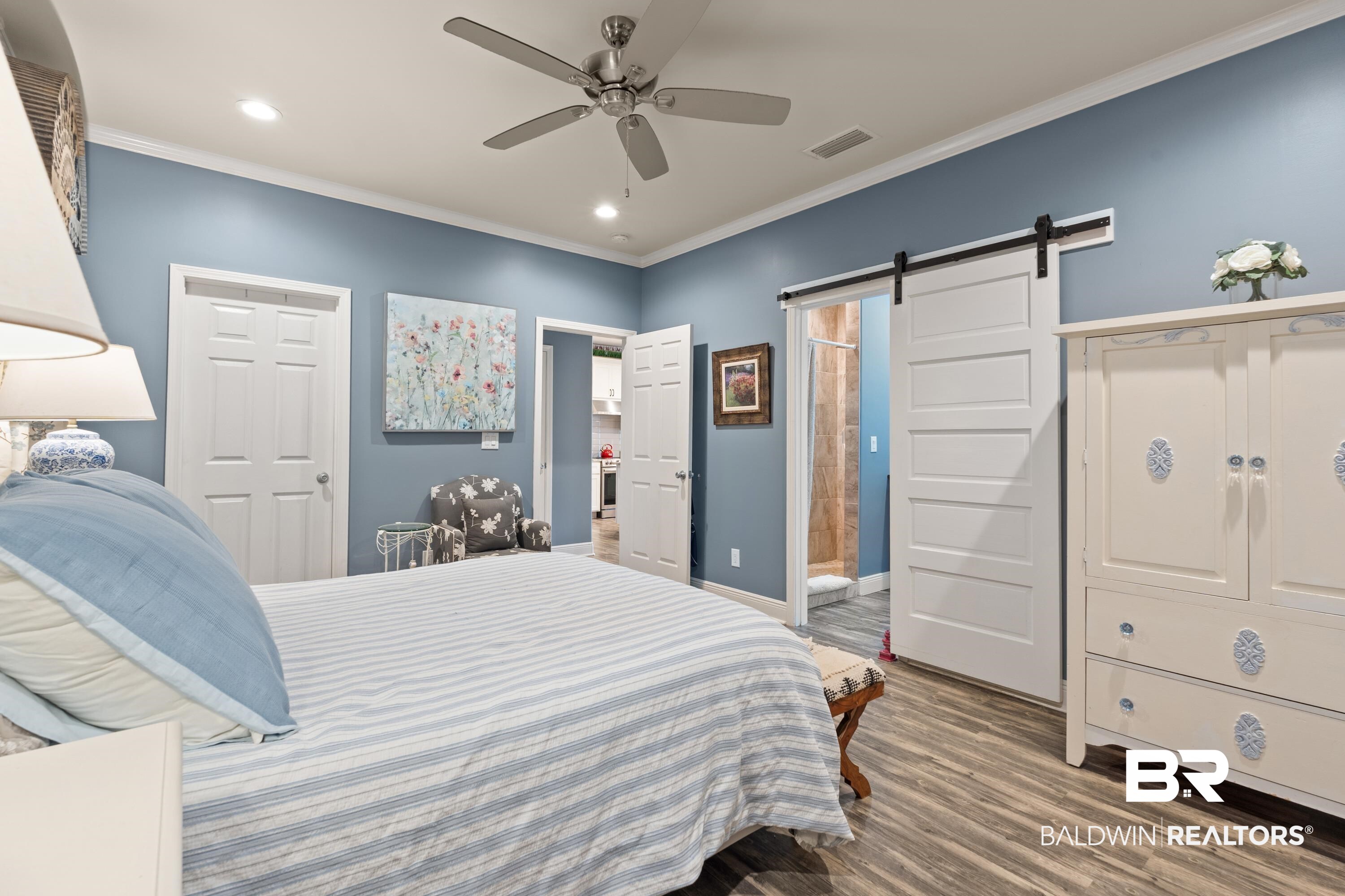 1113 Yellow Daisy Lane Foley, AL 36535 - Photo 17 of 35 Bedroom featuring ornamental molding, a barn door, wood finished floors, recessed lighting, and a ceiling fan