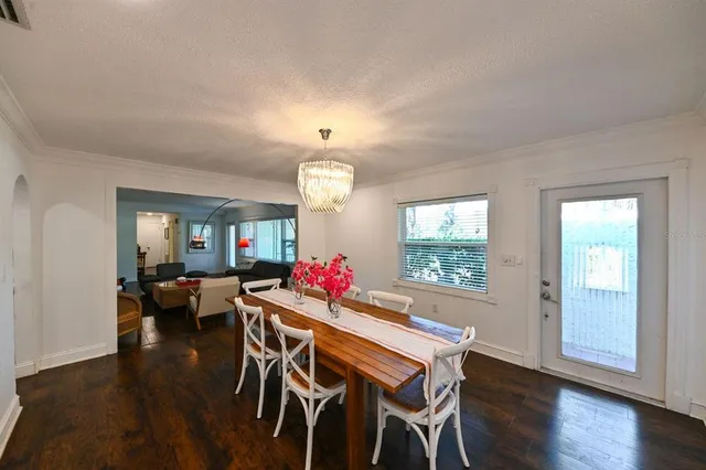 a view of a dining room with furniture wooden floor and chandelier