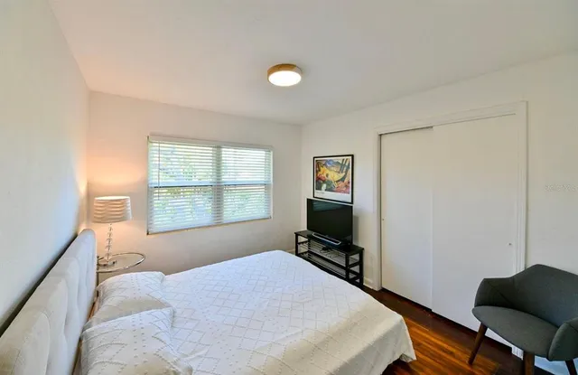 a bedroom with a bed and a window