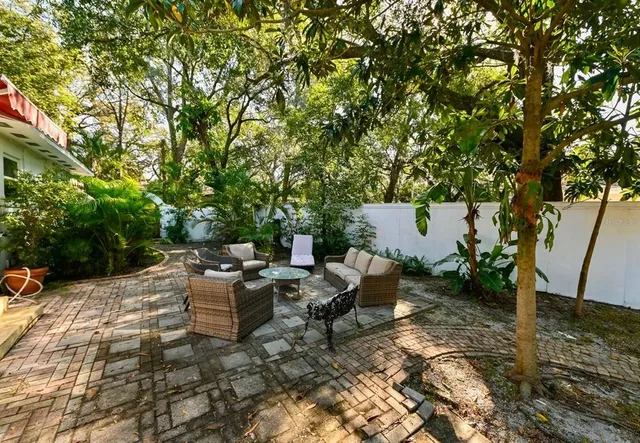 a view of backyard with sitting area