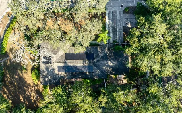 an aerial view of a house with a yard