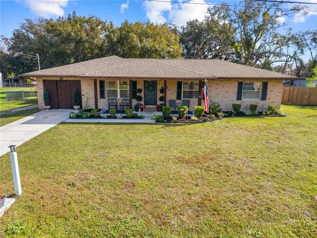 a front view of a house with swimming pool having outdoor seating