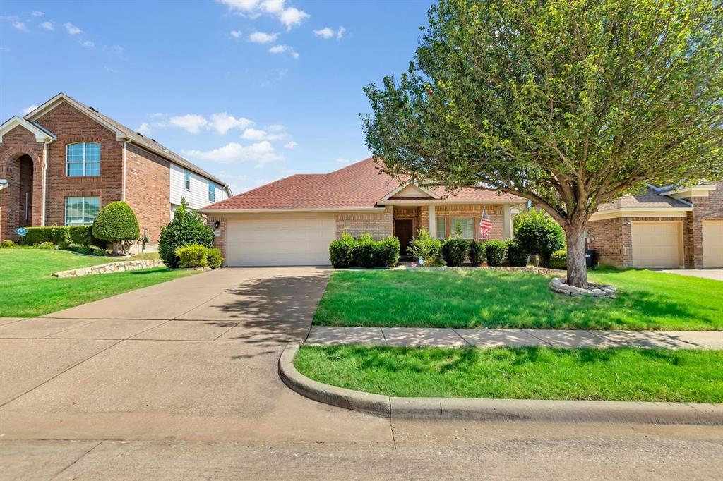 5316 Ridgeson Drive McKinney, TX 75071 - Photo 9 of 33 Single-story brick exterior featuring an attached two-car garage, concrete driveway, and a front lawn with mature landscaping