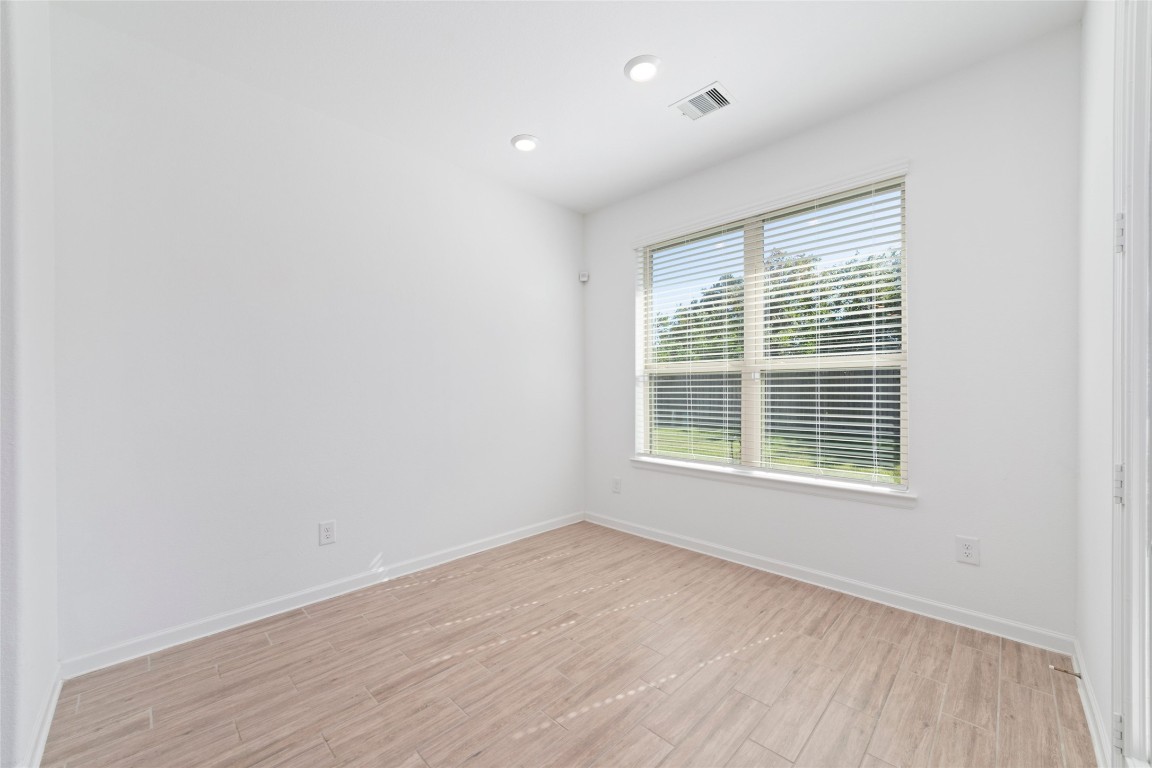 11023 Abendstern Road Tomball, TX 77375 - Photo 20 of 26 a view of an empty room with wooden floor and a window