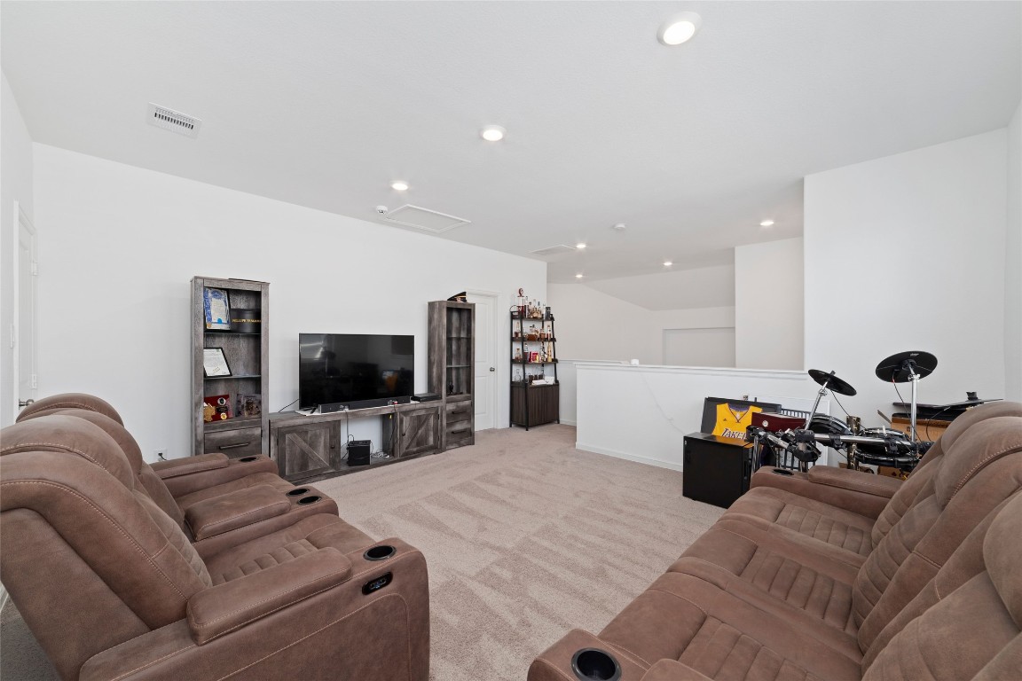 11023 Abendstern Road Tomball, TX 77375 - Photo 25 of 26 a living room with furniture and a flat screen tv