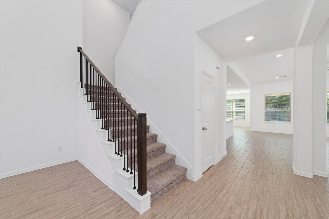 11023 Abendstern Road Tomball, TX 77375 - Photo 4 of 26 a view of a hallway with wooden floor and stairs