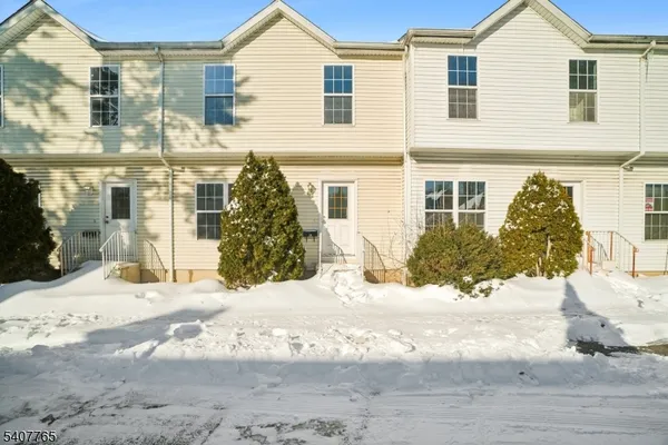 a view of a house with snow on the road