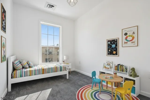 a bedroom with furniture and lounge chair